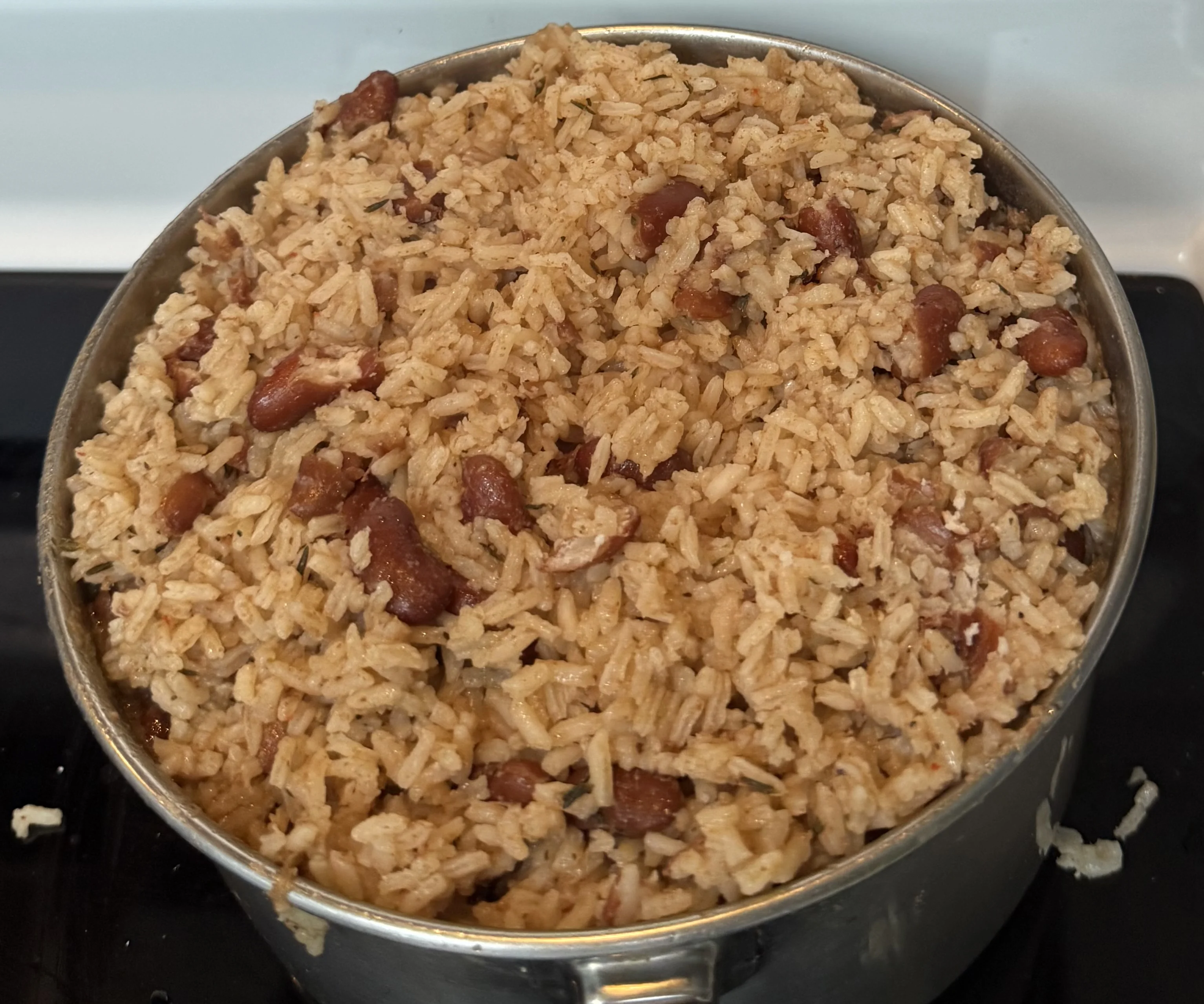 A pot of fluffed rice and red kidney beans, cooked and ready to serve